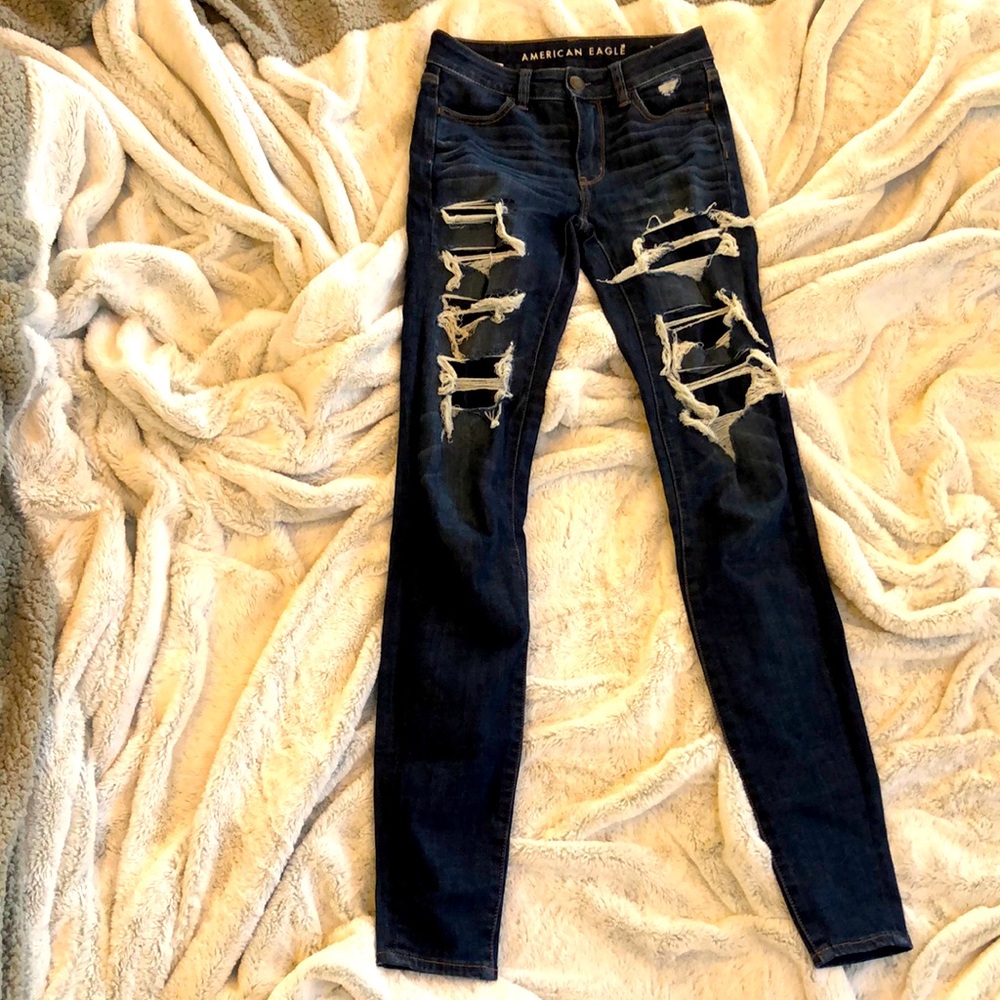 Stylish distressed ripped bluejeans American eagle